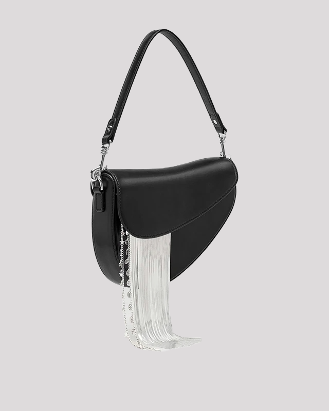 Side view of black asymmetric shoulder bag by Bafelli with hanging silver fringe chain detail