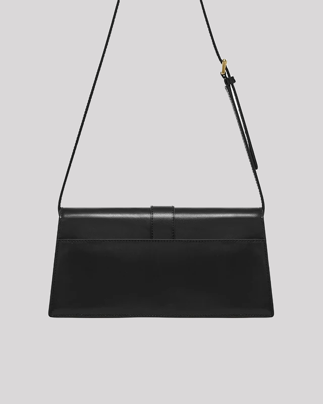 Open view of black cat-emblem shoulder bag by Bafelli showing interior compartments and gold clasp