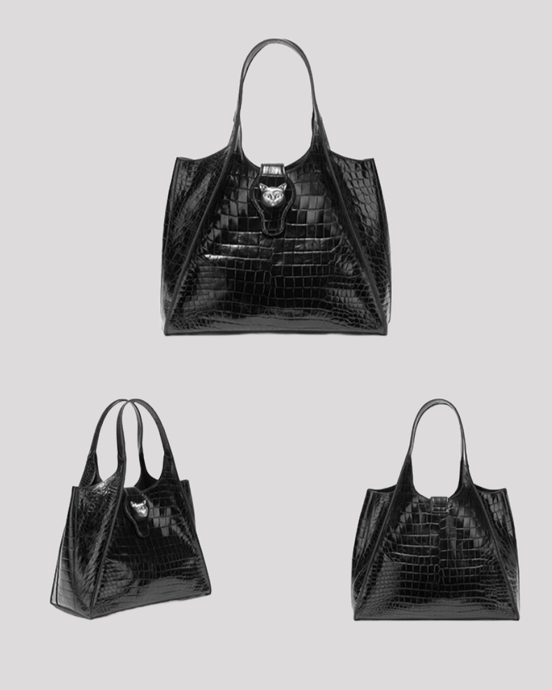Side angle of black croc-embossed tote bag by Bafelli showing shiny texture and dual handles