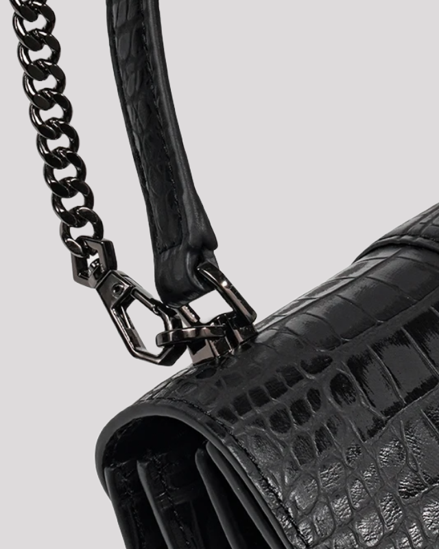 Close-up of black croc-embossed leather handbag by Bafelli handle with chain and leather detail