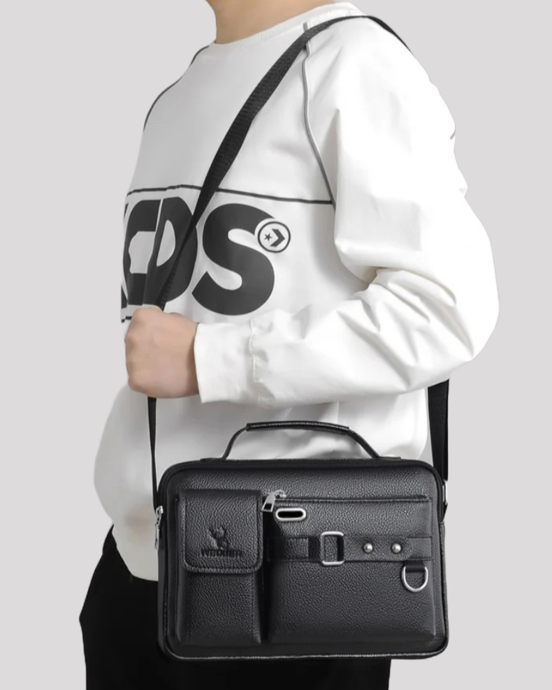 Man carrying black leather messenger bag on shoulder – side profile view