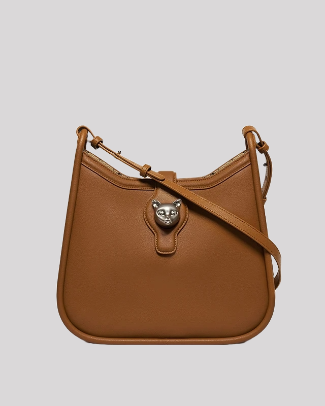 Front view of brown leather shoulder bag by Bafelli with silver cat-head clasp and crossbody strap