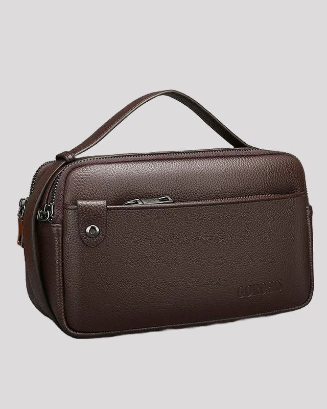 Side angle of brown leather men’s handbag with textured finish and top handle