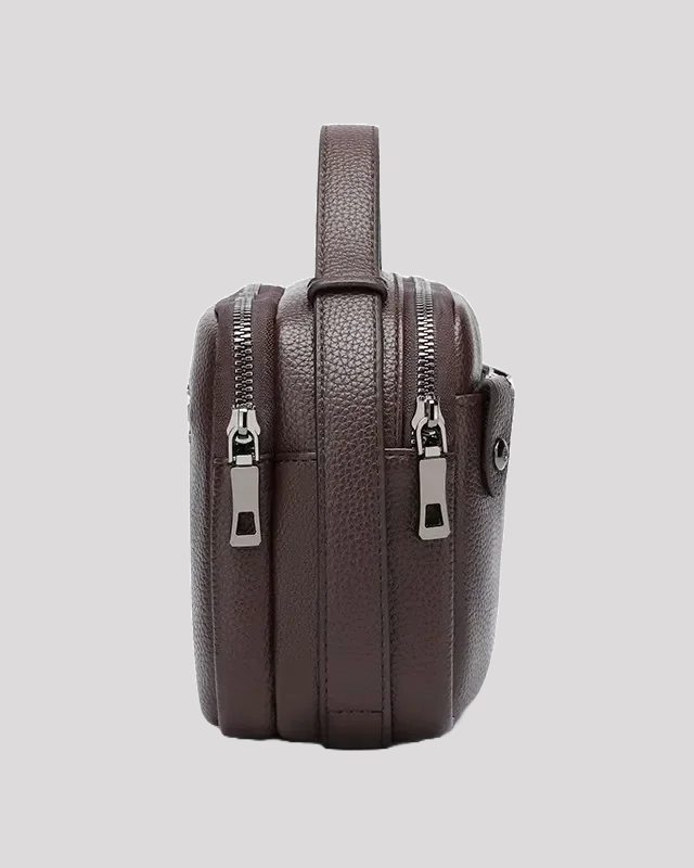 Side profile of brown leather men’s handbag with double zippers