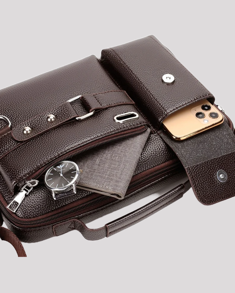 Close-up of brown leather messenger bag pocket with phone, notebook, and watch inside