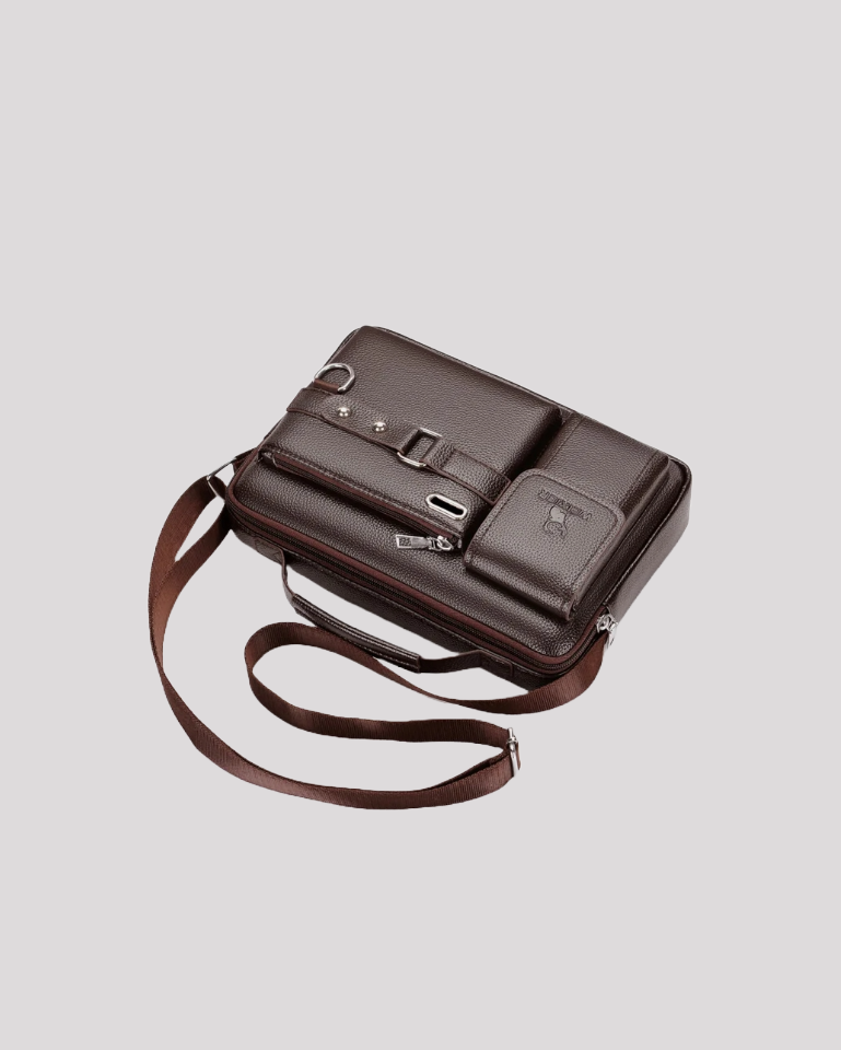 Angled side view of brown leather messenger bag with strap and pockets