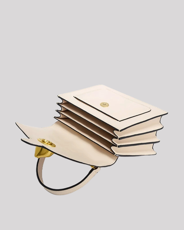 Interior view of cream and black handle bag by Bafelli with multiple compartments for organized storage