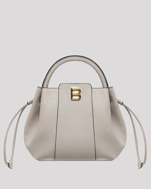Front view of gray textured leather bucket bag by Bafelli with structured silhouette, drawstring sides, and gold B logo hardware
