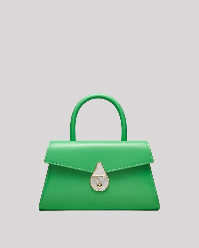 Front view of green mini top-handle bag by Bafelli with structured shape and pearl clasp closure