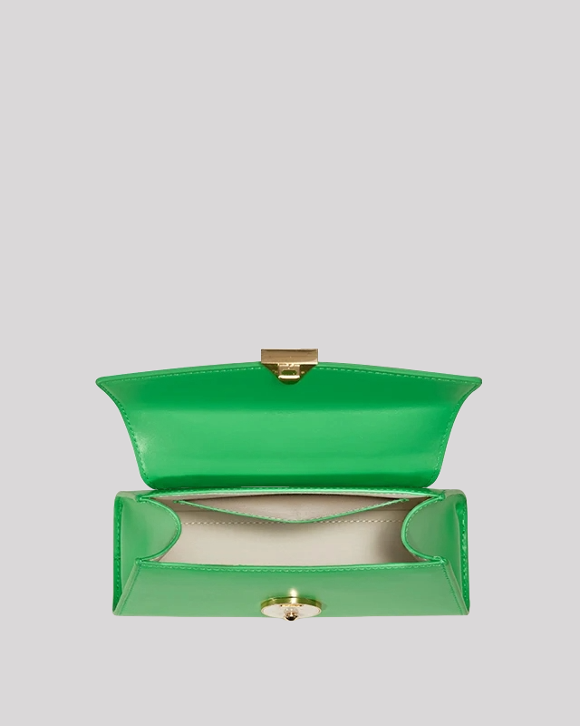 Interior of green mini top-handle bag by Bafelli showing spacious compartment and light lining