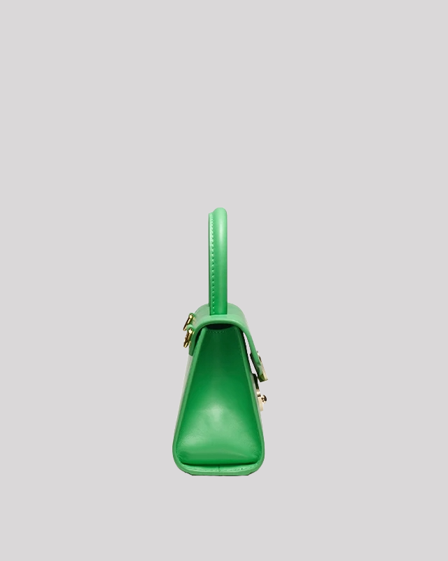 Slim side profile of green mini top-handle bag by Bafelli highlighting trapeze structure