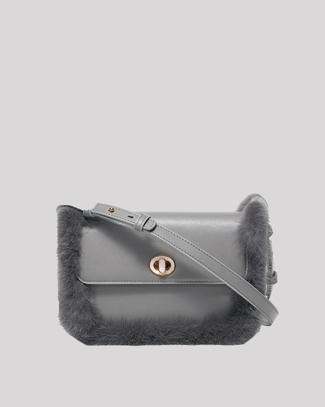 Front view of grey fur-trim crossbody bag by Bafelli with gold turn-lock closure and leather strap