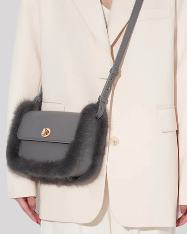Grey crossbody bag by Bafelli with soft fur trim worn on the shoulder