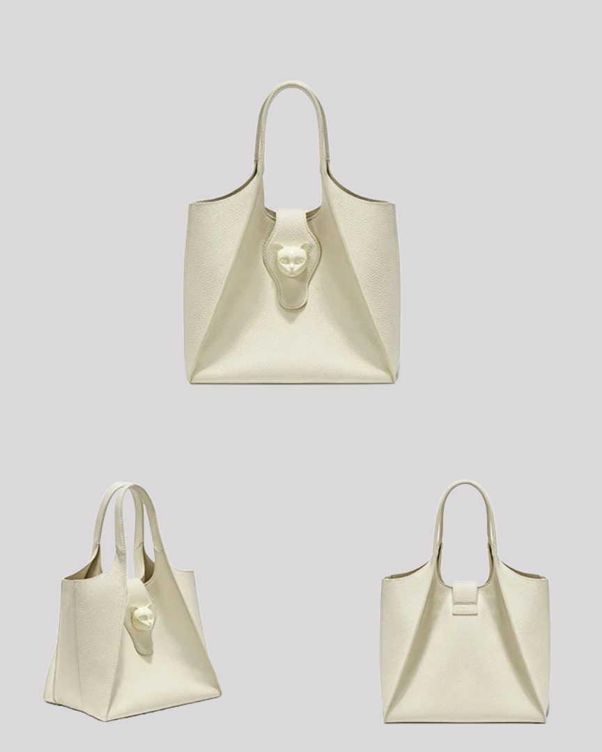 Multiple angles of ivory leather tote bag by Bafelli showcasing side profile, front with cat emblem, and smooth back design