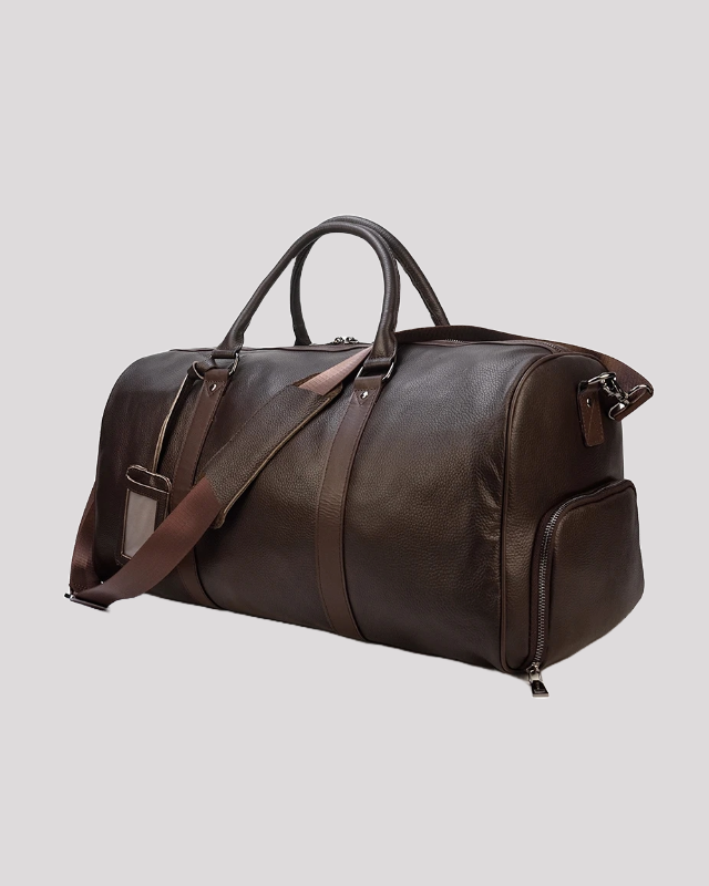Men’s brown leather duffle bag – angled view with adjustable strap attached