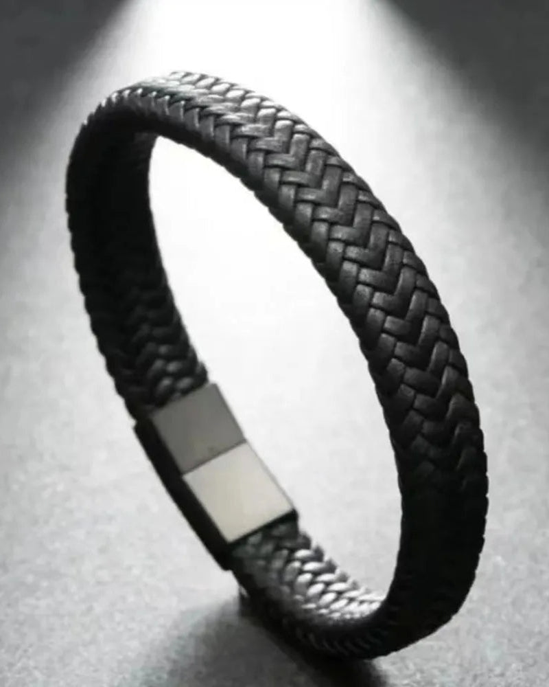 Close-up of men’s braided black leather bracelet with magnetic clasp
