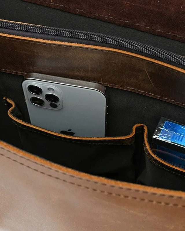 Close-up of mocha leather messenger bag – inner pocket with smartphone and accessories
