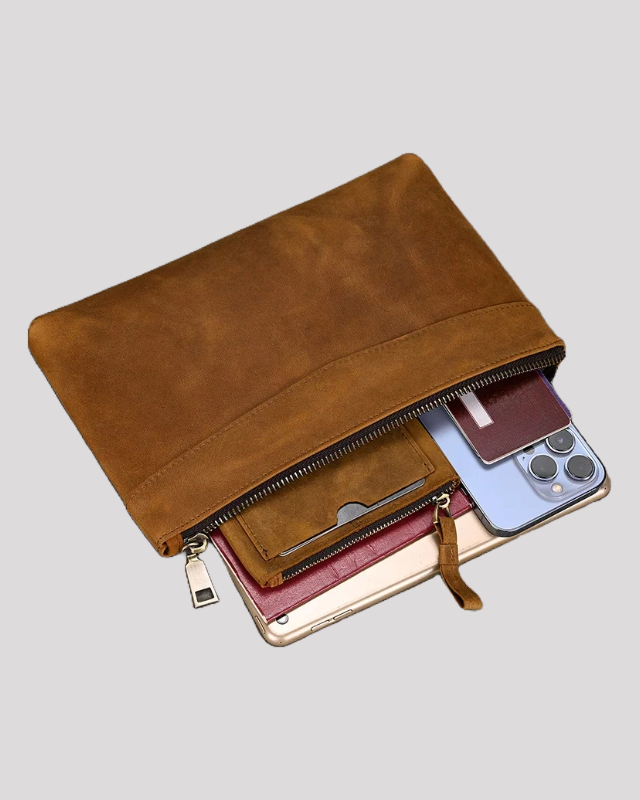 Mocha leather clutch bag filled with phone, wallet, and tablet – open view
