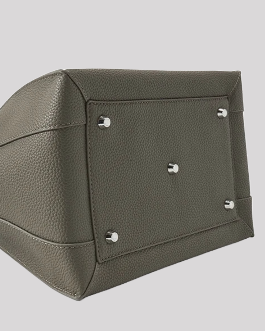 Bottom view of olive green leather tote bag by Bafelli showing reinforced base with silver protective studs