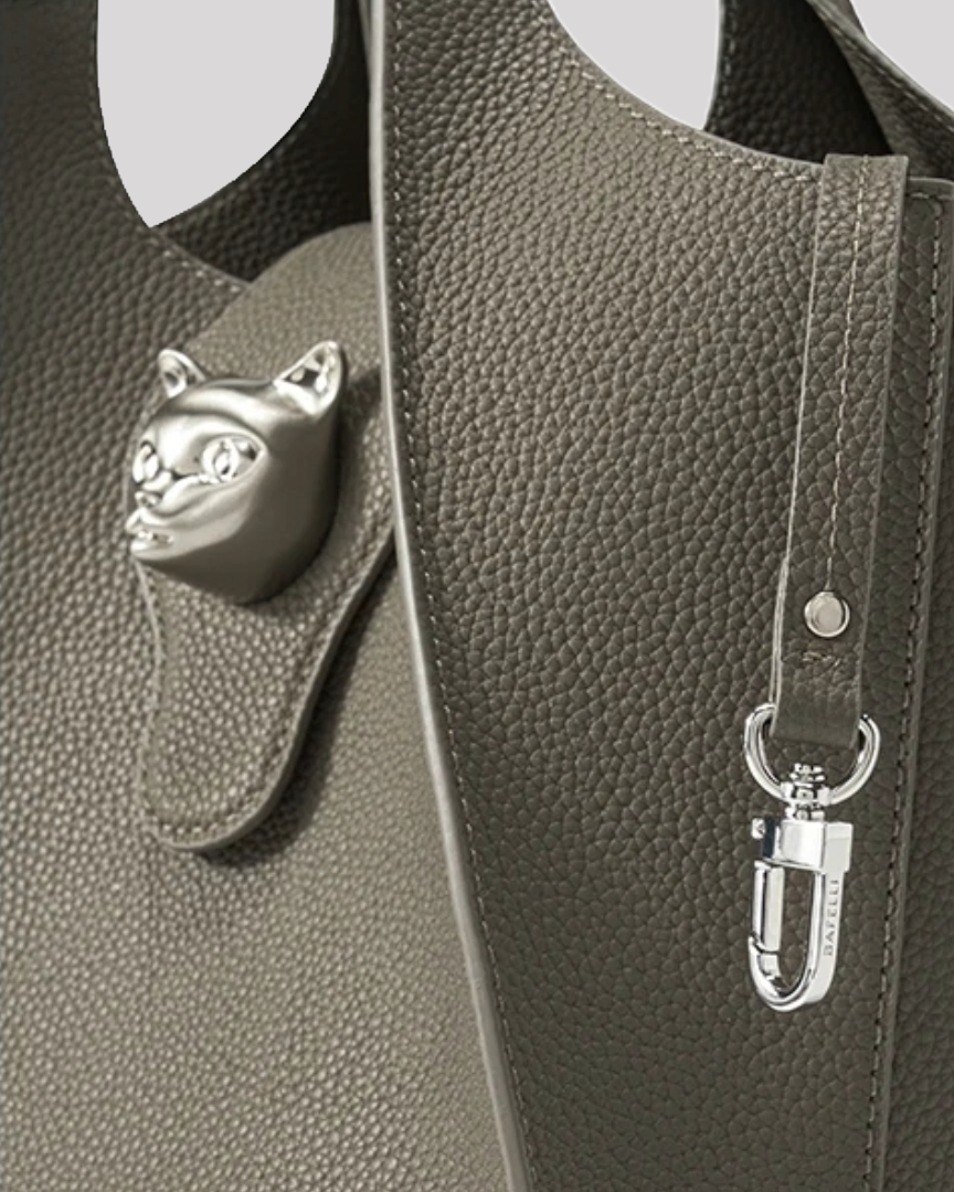 Detail of adjustable olive green leather shoulder strap by Bafelli with silver hardware