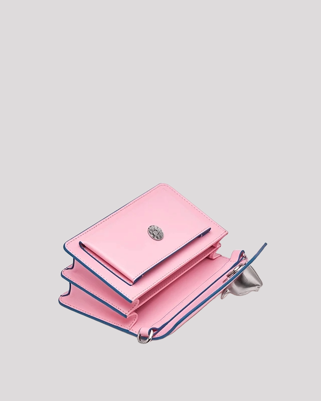 Interior view of pink envelope crossbody bag by Bafelli with multiple compartments and silver cat head clasp