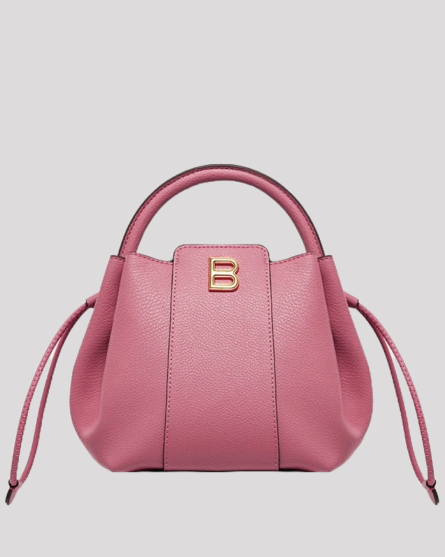 Front view of pink mini bucket bag by Bafelli with gold "B" logo and drawstring sides