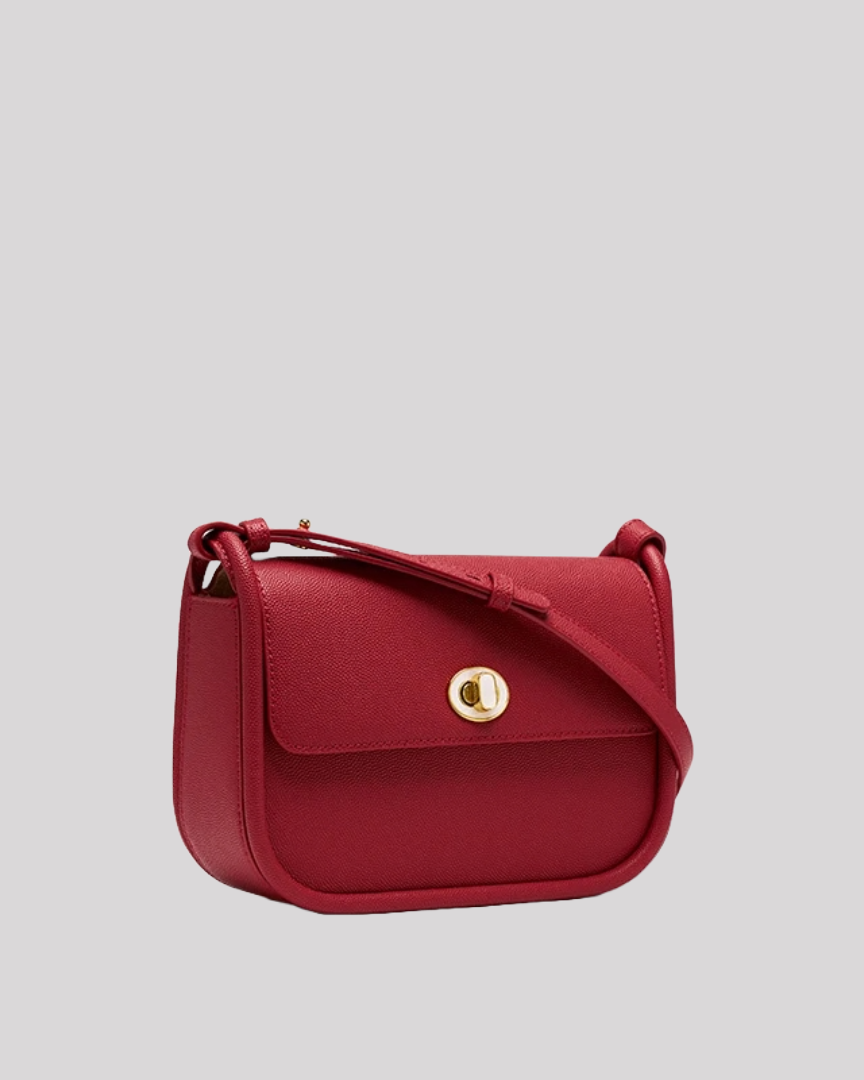 Angled side view of red crossbody bag by Bafelli showing structured silhouette and long strap
