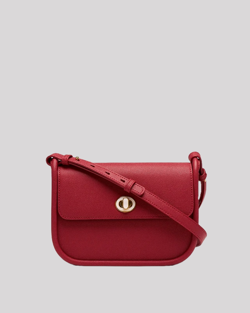 Front view of red crossbody bag by Bafelli in textured leather with gold turn-lock closure and slim adjustable strap