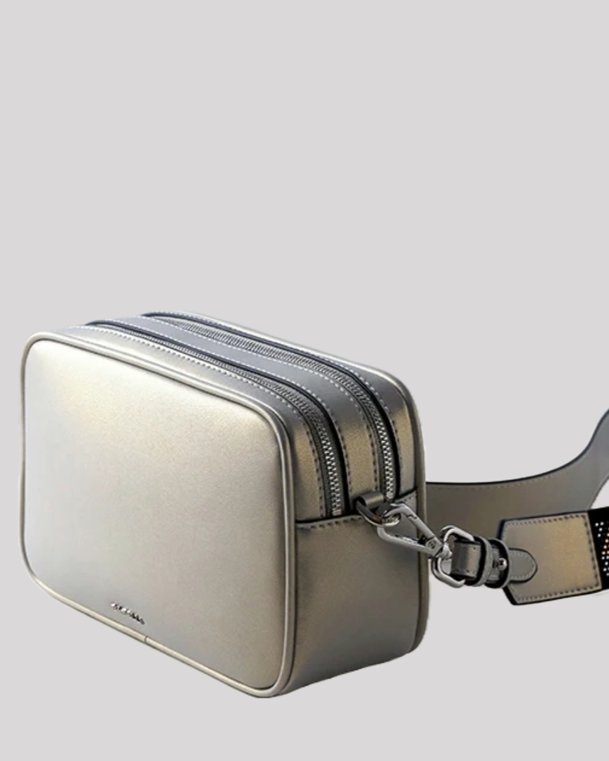 Side angle of silver crossbody bag by Bafelli with dual top zippers and detachable strap