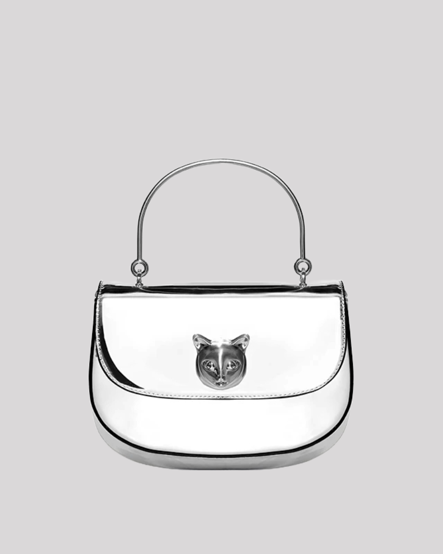 Front view of silver metallic handbag by Bafelli with reflective finish and cat emblem