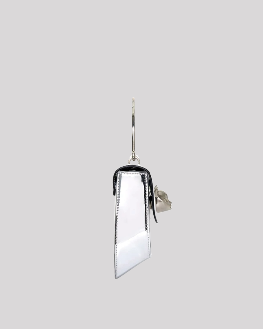 Side profile of silver metallic handbag by Bafelli with sleek reflective surface