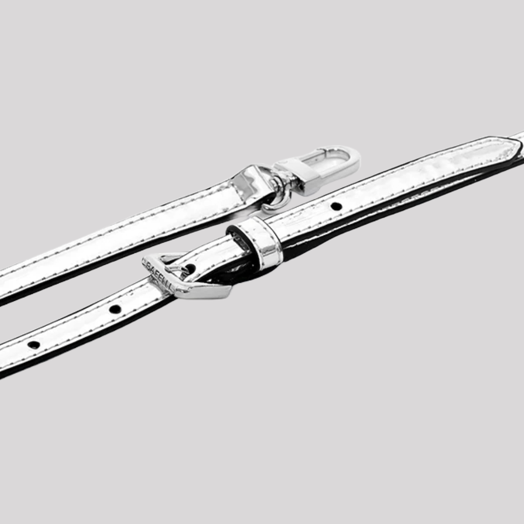 Detailed view of adjustable silver metallic handbag by Bafelli strap with buckle and clasp