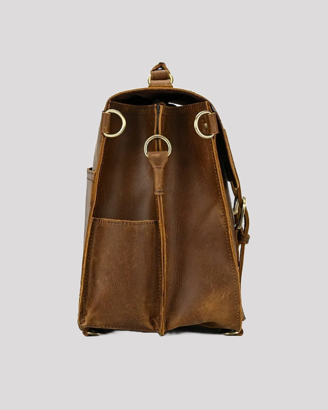 Side pocket of vintage mocha leather messenger bag with D-ring details