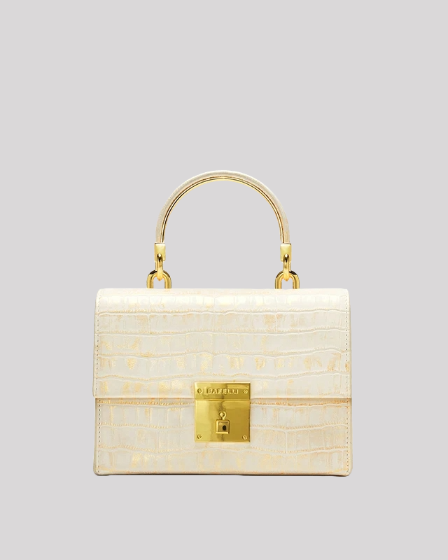 Front view of white croc-embossed top handle bag by Bafelli with gold lock closure and structured design