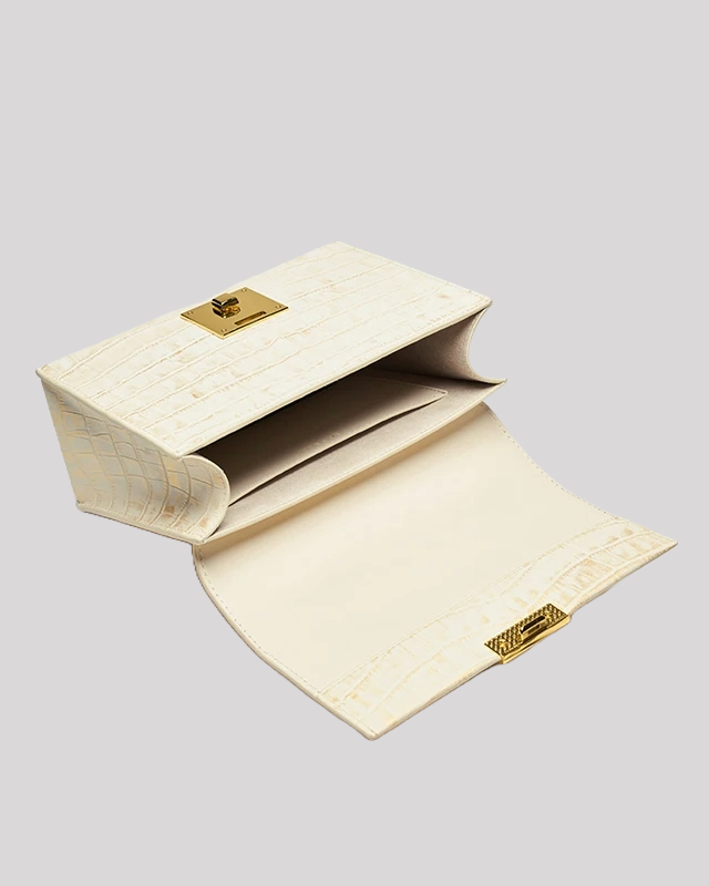 Open view of white croc-embossed top handle bag by Bafelli showing spacious interior with flap closure
