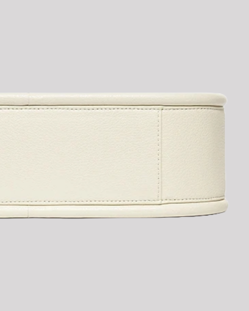 Bottom view of white leather shoulder bag by Bafelli showing stitching and smooth structure