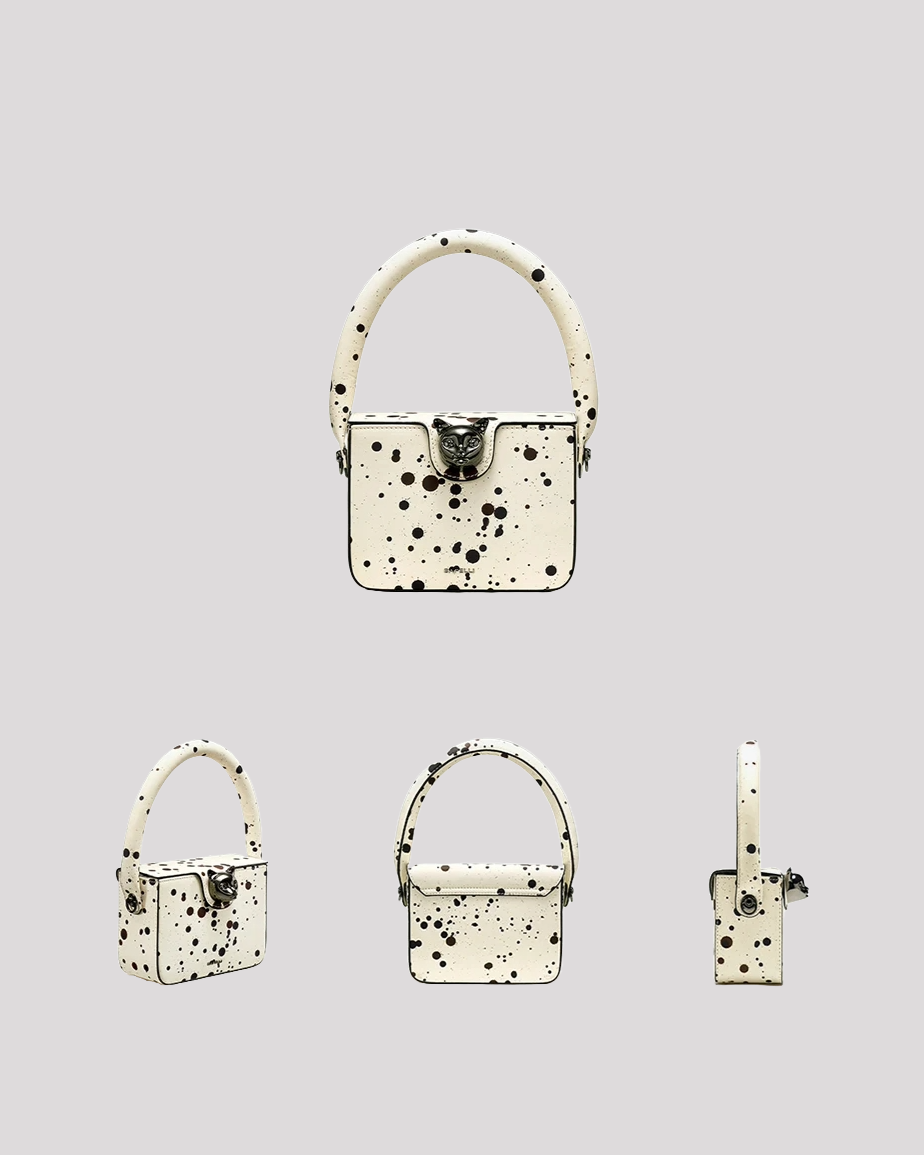 Multiple angles of white speckled box bag by Bafelli– front, side, back, and angled views with cat clasp detail
