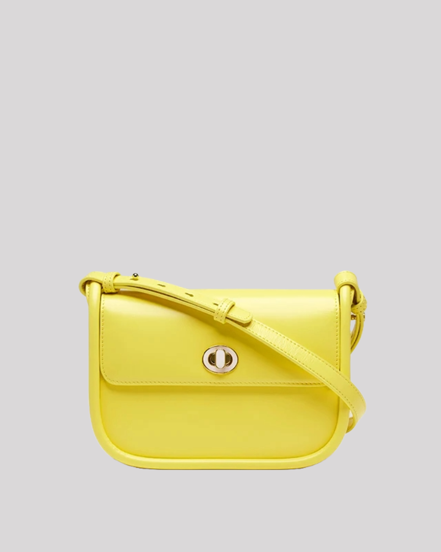 Front view of yellow leather shoulder bag by Bafelli with flap closure and gold turn-lock