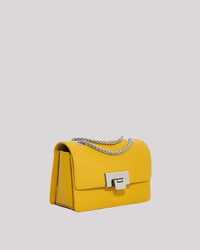 Angled view of yellow mini crossbody bag by Bafelli with structured shape, chain strap, and clasp closure