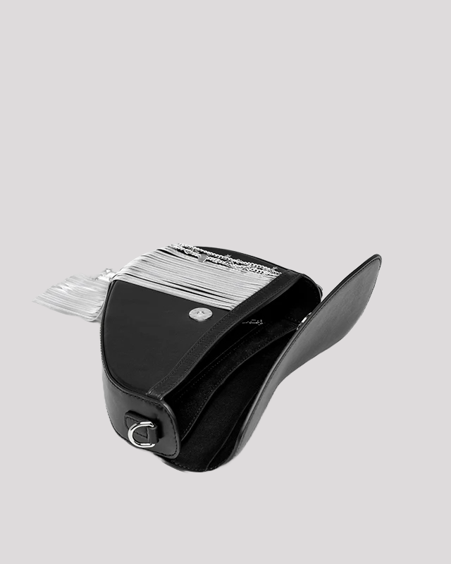 Open view of black asymmetric shoulder bag by Bafelli showing spacious interior with silver fringe chain detail on flap