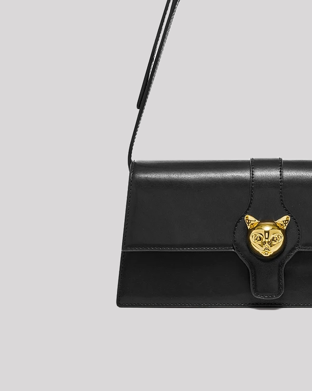 Back view of black cat-emblem shoulder bag by Bafelli with clean leather finish and rectangular cut