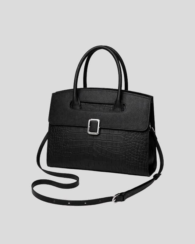 Front angle view of black croc-embossed leather handbag highlighting structured silhouette and silver buckle