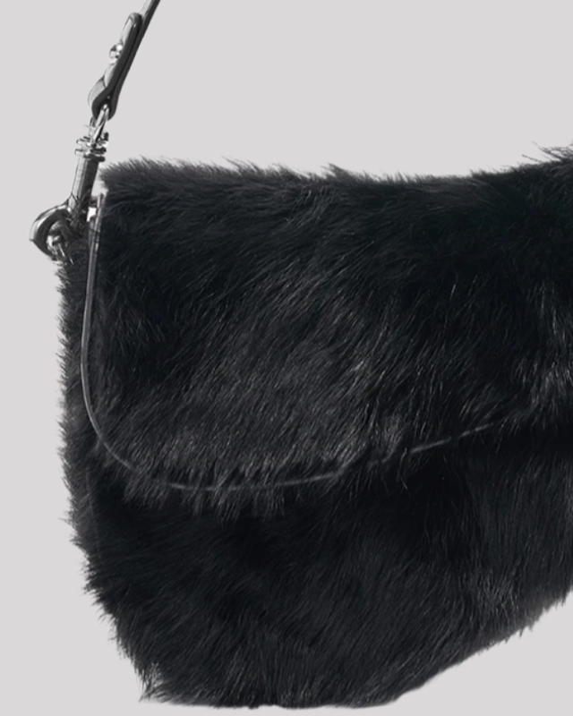 Close-up of black faux fur shoulder bag by Bafelli highlighting fluffy material and silver hardware