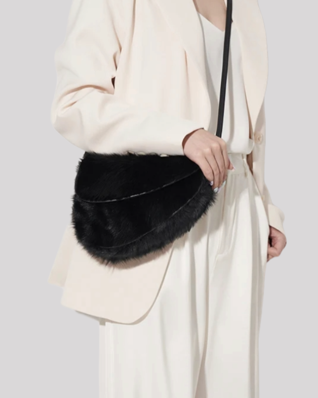 Black faux fur shoulder bag by Bafelli worn crossbody with minimalist cream outfit
