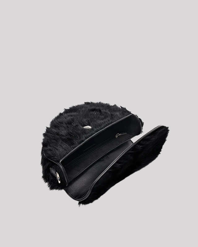 Inside view of black faux fur shoulder bag by Bafelli with flap open showing spacious interior