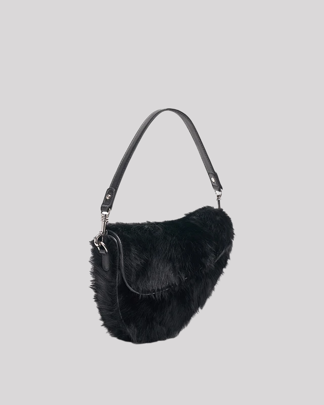 Side view of black faux fur shoulder bag by Bafelli showing fluffy texture and sleek strap