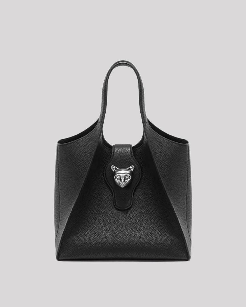 Front view of black leather tote bag by Bafelli with silver cat emblem clasp and structured silhouette
