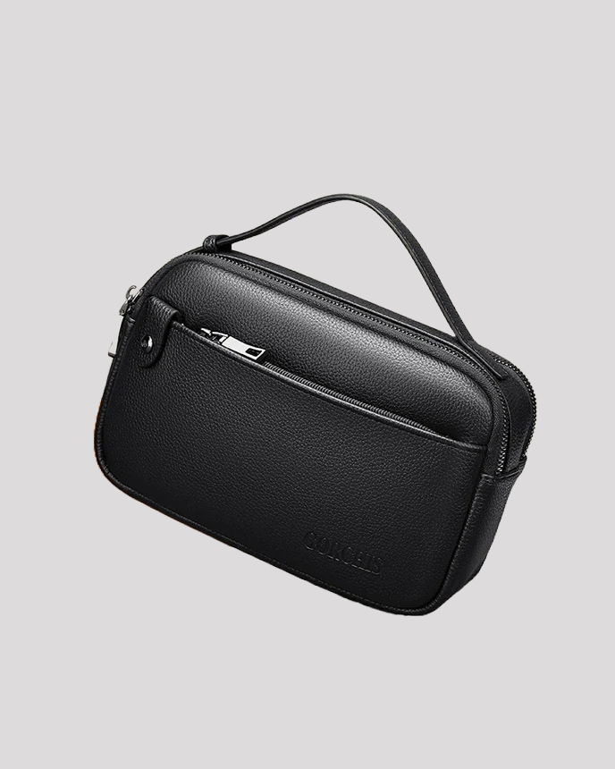 Angled side view of black leather clutch bag with smooth texture