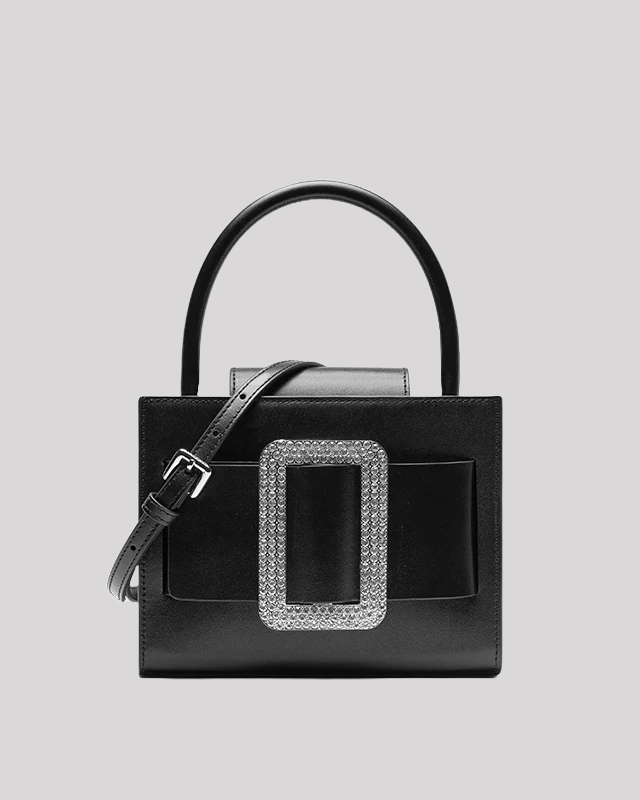 Front view of black leather handbag by Bafelli with large rectangular crystal buckle and detachable shoulder strap