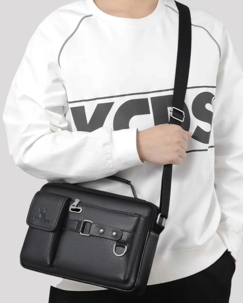 Man wearing black leather messenger bag crossbody – casual outfit view